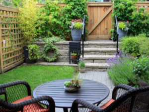 best granny flat garden ideas in sydney - image of small backyard with 2 black chairs and black table - call premier granny flats today