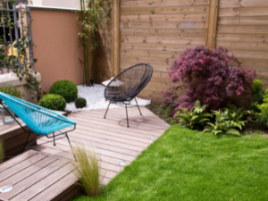 Low Maintenance Lawns for Granny Flat Gardens in Sydney - image of blue and black chairs on walkway with low maintenance lawn and gardens - call premier granny flats today
